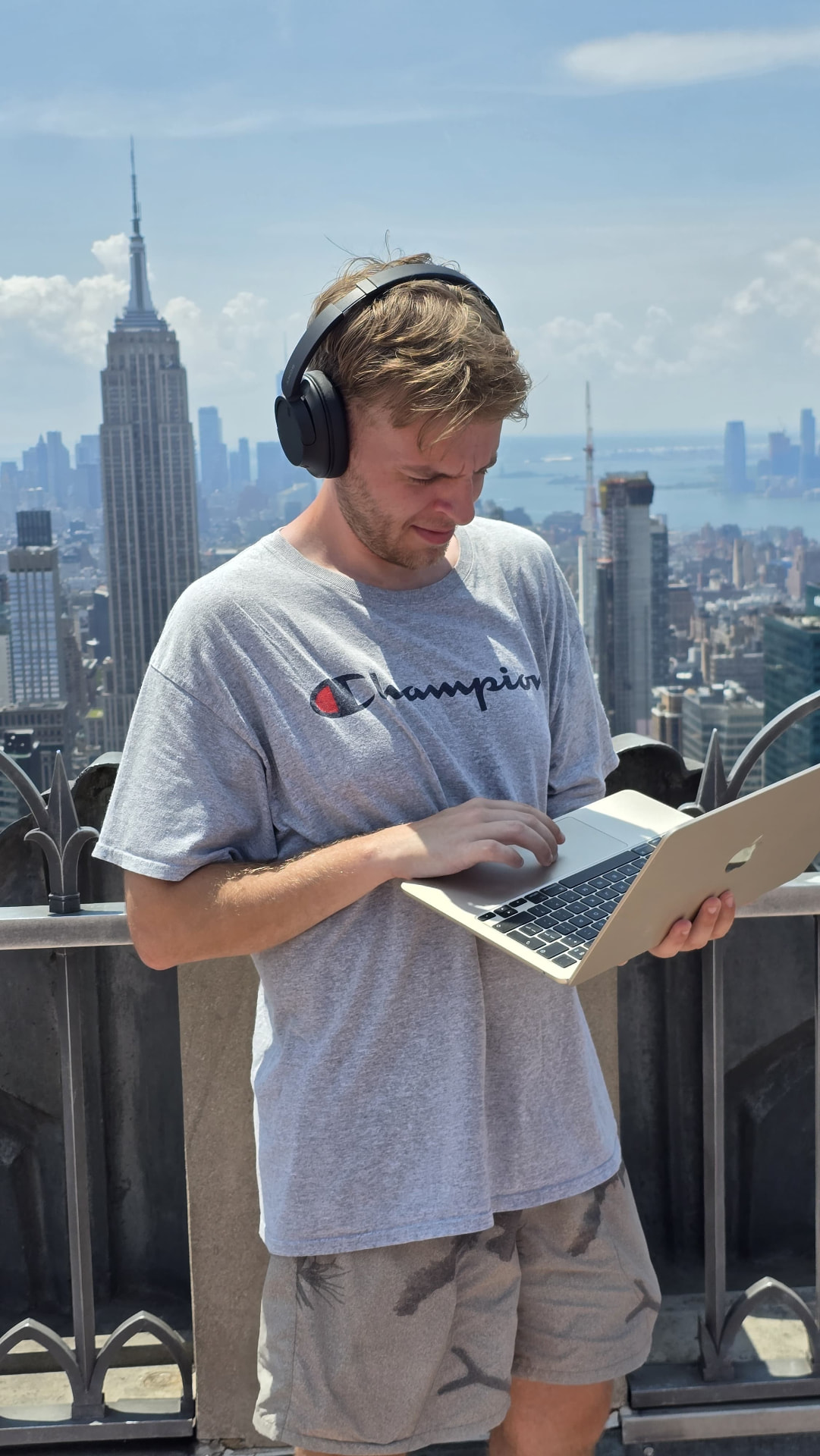 Ryan Trevis working on a laptop in New York during a street interview shoot trip